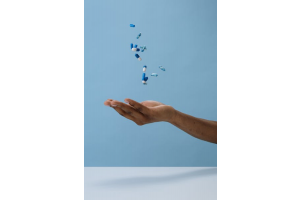 a person tossing some pills in the air